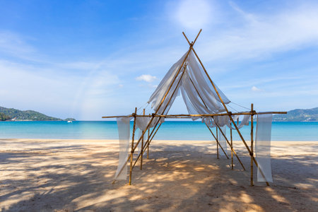 Beautiful tropical beach the calm sea with cloud and sky background. Sun over tropical beach. Nature summer  concept. Bamboo and white cloth theme for camera shot on beachの写真素材