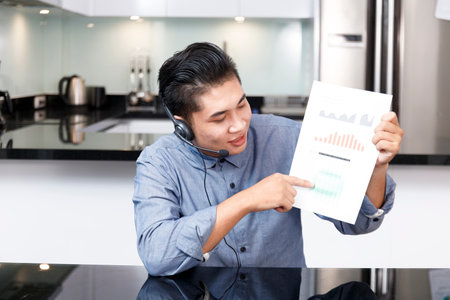 Screen of businessman talking with video call, video conference meeting at home. Business people working at home with online video call looking at cameraの写真素材