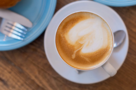 Top view Close up hot cappuccino, latte on table with blur coffee shop background. Hot cappuccino...