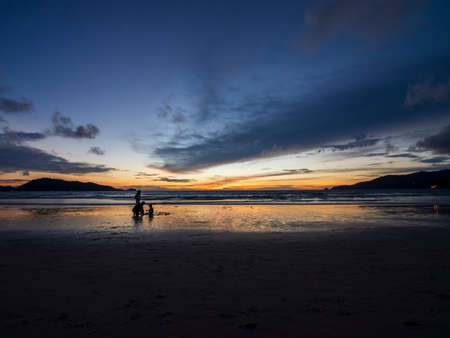 Beautiful sunset over the clam sea with cloud sky background. Sunset over tropical beach. Nature summer  concept. Peak sunset over sea with yellow light reflect on sea water. Tranquil seascape. Horizon over the water.の写真素材