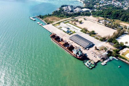 Aerial drone top view of containers cargo ship at industrial import-export port. Business logistic import and export freight transportation by container ship in open seaの写真素材