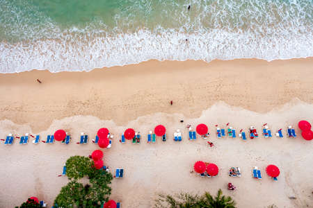 Aerial drone top view crowd of happy people relax at tropical Beach with sunset in Phuket, Thailand, Beautiful Phuket beach is famous tourist destination at Andaman sea. Holiday summer conceptの写真素材