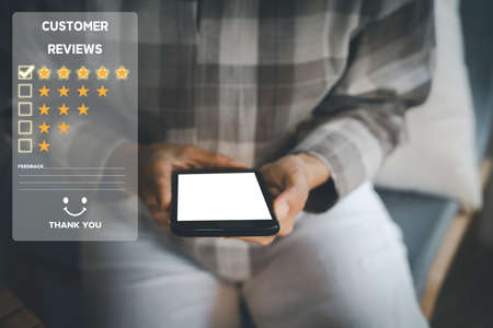 Customer service and Satisfaction concept ,Women hand hold smart phone empty screen choose the 5 star icon to give satisfaction in service. rating very impressed in coffeeshop.の写真素材