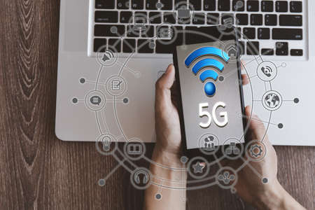 Top view hand of women hold mobilephone connect network 5G with icon concept, technology network wireless systems and internet of things, new technologies coming up in the future. Network connection 5Gの写真素材