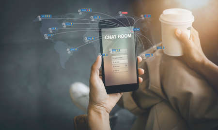 Women hands hold and use a telephone connect social network with people around the world. Women relax with mobilephone and coffee chat with friend on morning. Female use phone social media connectionの写真素材