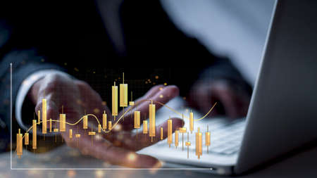 Businessman show golden stock market bar chart grow up to target. Business finance concept. Businessman's hands Show success graph, stocks grow every yearの写真素材