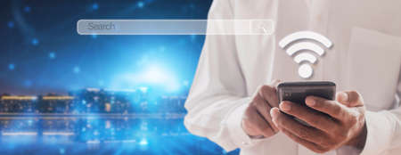 Hand man using mobile phone with search bar connect to social media, social network Online marketing concept Man hand holding smartphone with search bar Lifestyle business concept copy space bannerの写真素材