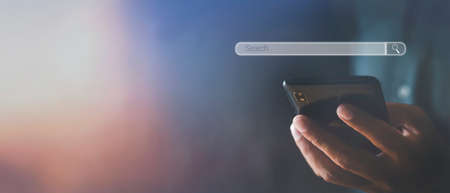 Hand man using mobile phone with search bar connect to social media, social network Online marketing concept Man hand holding smartphone with search bar Lifestyle business concept copy space bannerの写真素材