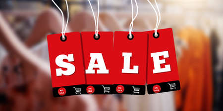 Red hanging sales tags on blur clothing store. Red sale price tag style banner design template.の写真素材