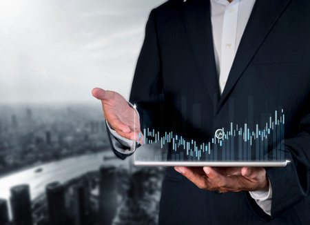 Hand of businessman holding tablet analysis stock market graph growth and increase of chart positive...