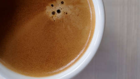 Close up Coffee froth on a hot coffee cup. Ready to drink hot cofffeeの写真素材