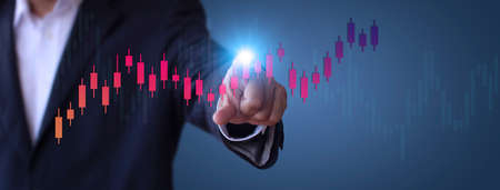 Businessman show stock market bar chart grow up to target. Business finance concept. Businessman's hands Show success graph, stocks grow every year  With copy space bannerの写真素材