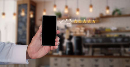 Businessman use the virtual screen check mark joyful Smile face icon to give happiness in service. Customer service and satisfaction concept. Very impressed with the rating.の写真素材