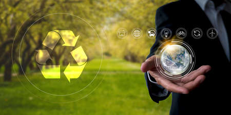 Environment concept Business man hold and show global with eco icon. business man using tablet to analyze environmental conservation industry Environmental protection business for a sustainable futureの写真素材