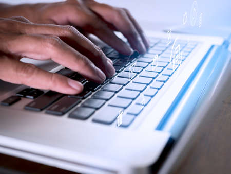 Hands man useing laptop computer with E-commerce technology icons on virtual screen. Business global, social media marketing concept.の写真素材