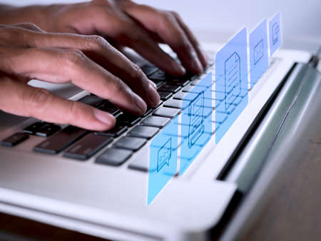 Hands man useing laptop computer with E-commerce technology icons on virtual screen. Business global, social media marketing concept.の写真素材