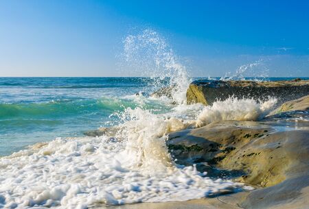 Ocean surf broken over coast rocksの写真素材