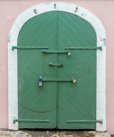 Old gate in the wall of buildingの写真素材