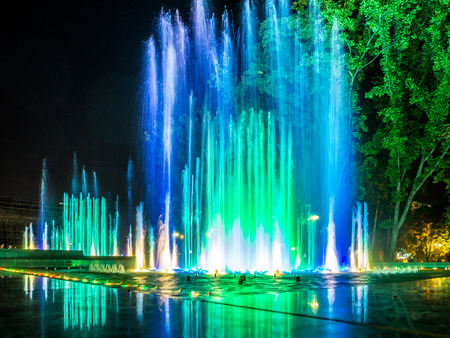Colorful music fountains in the late evening の写真素材