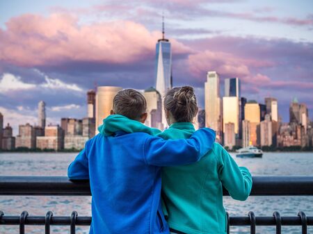 Kids looking at Manhattan Downtown panorama from Jersey City waterfrontの写真素材