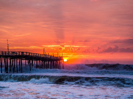 Serene sunrise over fishing pier at North Carolina Outer Banksの写真素材