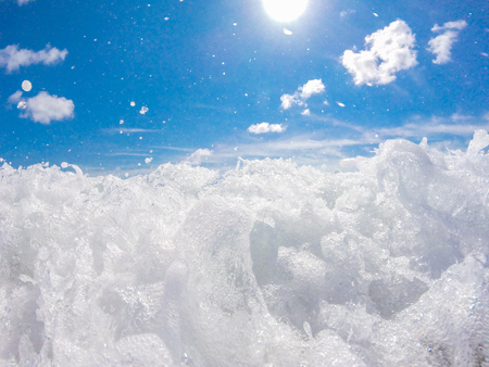 Close-up photo of ocean surf at sandy beachの写真素材