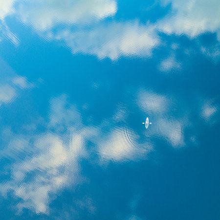 Aerial photo on kayak with mirrored cloudy sky reflected in the water