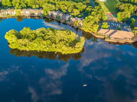 Aerial stock photo of the lake among the countryside living communityの写真素材