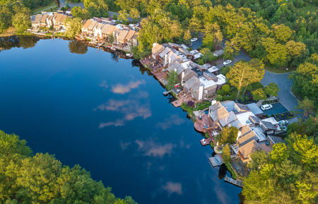 Aerial stock photo of the lake among the countryside living communityの写真素材
