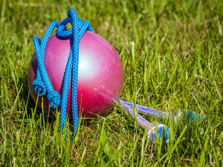 Rhythmic Gymnastics equipment in the grass during outdoor practice の写真素材