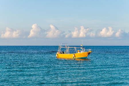 Boat on anchor at eraly morning in a lagoon in Caribbean seaの写真素材