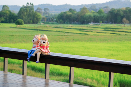 girl and boy sitting in a field with a refreshing atmosphere.の写真素材