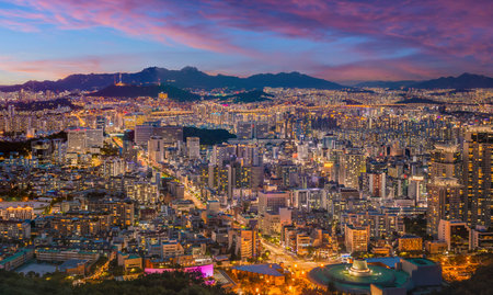 Panorama of Seoul city skyline and skyscrapers at night with Namsan Mountain and Bukhansan in the background, Seoul, South Korea.の写真素材