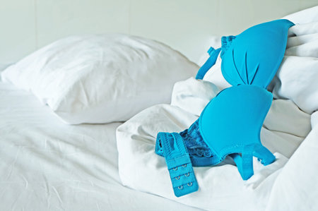 Lingerie over messy bed.の写真素材