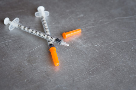 Close up syringe on Stainless Steel Table backgruond