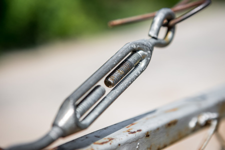 Turnbuckle on rusted iron fence with blurred backgroundの写真素材