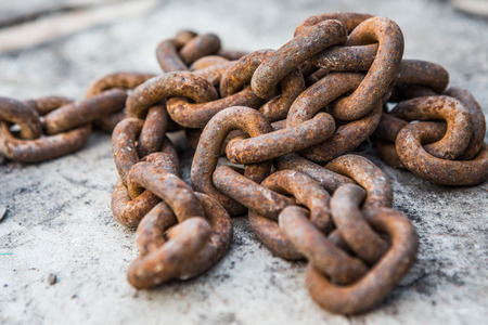 Rusty chain on the concrete floor backgroundの写真素材