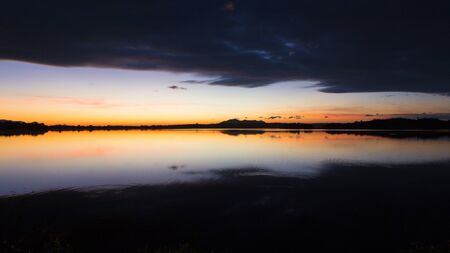 The beautiful morning sky is reflected on the waterの写真素材