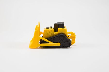 Yellow Construction vehicle toy on white backgroundの写真素材