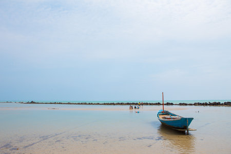 Rayong Thailand , February 24 , 2018 : Fishing boat and kids are playing on the beach and beautiful
 turquoise sea on a blue sky background and cloudsのeditorial素材