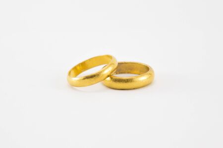Two gold rings on white backgroundの写真素材