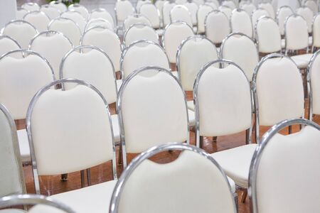 White chairs arranged in a seminar roomの写真素材