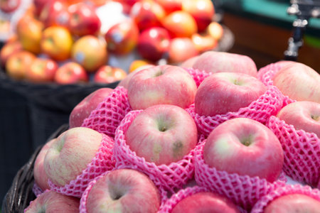 Many Apples on the shelves in the supermarket