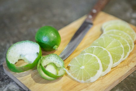 Lemon slice and knife on the cutting board