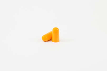 Orange earplug on white backgroundの写真素材