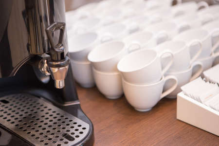 Electric Hot Water Maker with many White Coffee Cupの写真素材