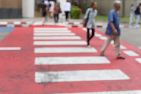 Blurred of People walking on a red crosswalkの写真素材