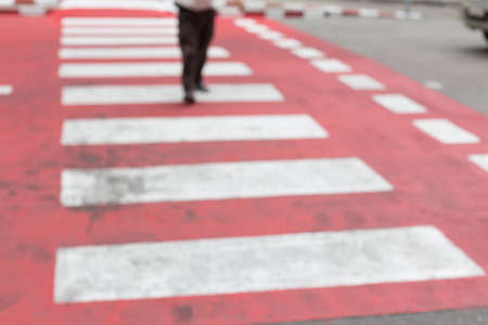 Blurred of People walking on a red crosswalkの写真素材