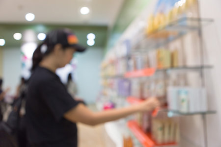 Blurred of women are picking up on shelves in supermarketsの写真素材