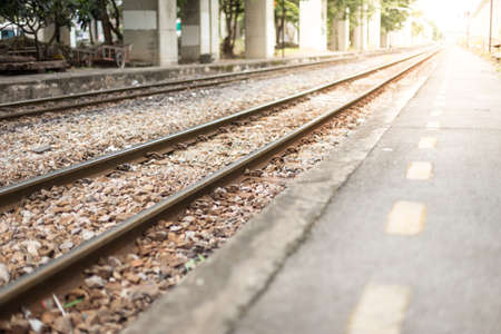 Selective focus of Railroad tracks with sunlight on blurred backgroundの写真素材